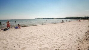 A beach with people swimming and relaxing.