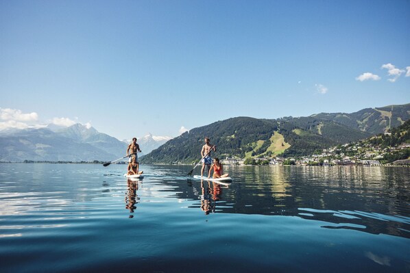 A calm lake with paddleboarders.