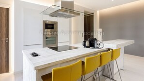 A modern kitchen with a central island, a built-in oven, and a coffee machine. - Clic 20-2121-Beautiful apartment on rue d'Antibes (Cannes)