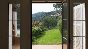 An open door to a balcony with a view of a green lawn and hills in the distance. - T2 1 bedroom 4 people for rent 83700 Saint Raphaël / Le Dramont  (Saint-Raphaël)
