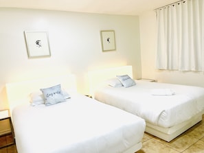 Two single beds with white linens and pillows, a white headboard, and a plain wall with two framed pictures. - 3BR condo Strip nearLVCC LasVegas Sphere best spot sale 4th of July pool BOOK (Las Vegas)