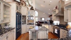 A spacious kitchen with white cabinetry, granite countertops, and a central island. - Laguna Beach Tranquility Base across from Jr. High.  Long Term Discounts (Laguna Beach)