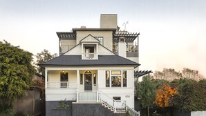 A two-story house with a balcony, a front porch, and a staircase leading to the entrance. - Hotel 850 SVB, a Member of Design Hotels (West Hollywood)