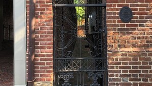 A brick building with a decorative iron gate and a plaque. - Duvall House - George Washington ate here! In the heart of Old Town Alexandria.  (Alexandria)