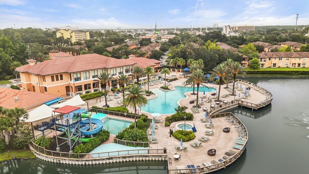 A resort with a swimming pool, water slides, and a dock. - Park all day, recharge in style- 10min to Disney, clean, revamped w/ resort pool (Kissimmee)
