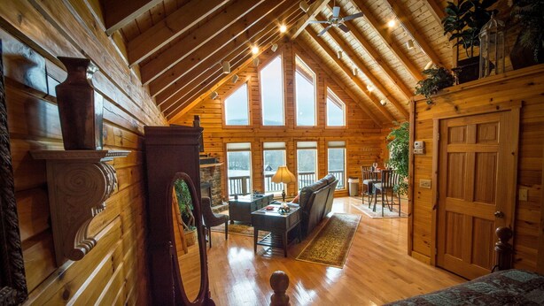 A cozy log cabin interior with a fireplace, wooden furniture, and large windows. - ✧Queen Cabin - wait until you see the BATHROOM! (Dryfork)