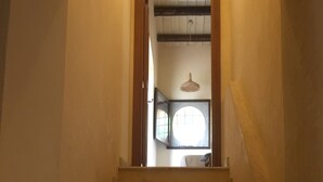 A staircase leading to a room with a window and a hanging light fixture. - Bed & Breakfast Baglio Fanara # 2 (Suite) (San Vito lo Capo)