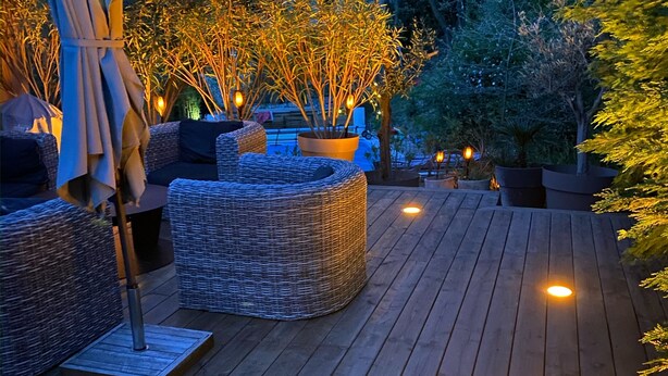An outdoor deck with wicker furniture and ambient lighting. - 5 bedroom VILLA with pool on a hillside near AIX  (Mimet)