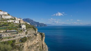 A coastal town with buildings on a cliff overlooking the sea.