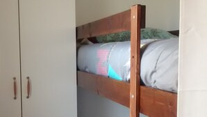 A bunk bed with a wooden frame and a wardrobe with two doors. - T1 standing entrance of CALVI  (Calvi)