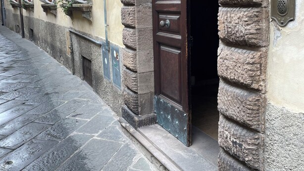 A stone building with a wooden door and metal window bars. -  Casa Reali - Italian dream in Lucca, Toscany  (Lucca)