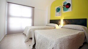 A bedroom with two beds, a large window, and two abstract paintings on the wall. - 177 Maravista (Denia)