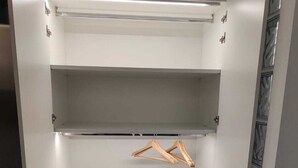 A walk-in closet with open doors, featuring two shelves and a hanging rod. - Terraced house with dehors adjacent beach in residence (San Teodoro)