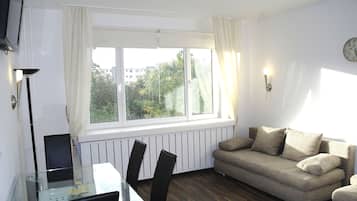 Apartment, 1 Bedroom, Balcony | Living room | Flat-screen TV