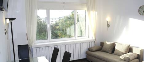Apartment, 1 Bedroom, Balcony | Living room | Flat-screen TV