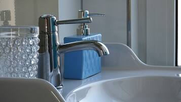 Combined shower/bathtub, hair dryer, towels, toilet paper