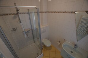Shower, hair dryer, towels, toilet paper