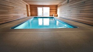 An indoor swimming pool with wooden walls and a tiled floor. - FOREST HILLS LODGE (19 pers) (Stoumont)
