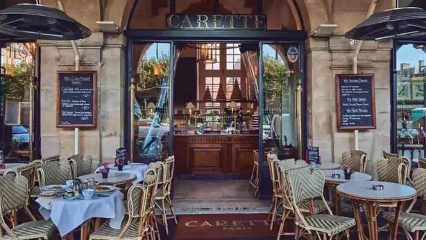 An outdoor cafe with wicker chairs and tables, a bar area, and menus on the walls. - ❤️❤️Paris Center Bastille Magnificient view Flat 3 rooms 2 bedrooms (Paris)