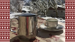 A stainless steel coffee pot and cup on a table with a snowy mountain backdrop. - L'Eterle de Motzon en Bauges: in the mountains, snow, skiing, hiking, relaxation... (Aillon-le-Jeune)