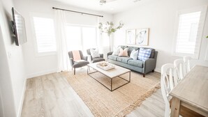 A modern living room with a grey sofa, two armchairs, a coffee table, and a dining table with chairs. - 💎 Blue Skies Ahead 💎- POOL IS OPEN!!! (Washington)