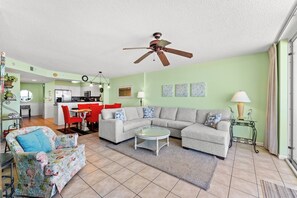 A living room with a sofa, armchair, coffee table, and a ceiling fan. - Spacious Updated Condo, Jacuzzi Tub, Lazy River | Windy Hill Dunes - 1203 (North Myrtle Beach)