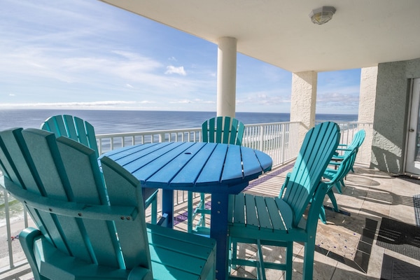 Oversize balcony with bistro table and high top chairs; 3 other chairs side tabl