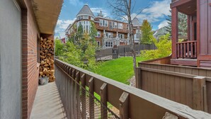 A balcony with a view of a large house with a stone facade and multiple windows. - Steps from the Mountain, in the iconic Old Town of Park City-2BR/2BTH Condo  (Park City)