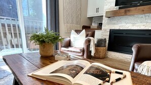 A cozy living room with a wooden coffee table, a leather sofa, and a fireplace. - Steps from the Mountain, in the iconic Old Town of Park City-2BR/2BTH Condo  (Park City)