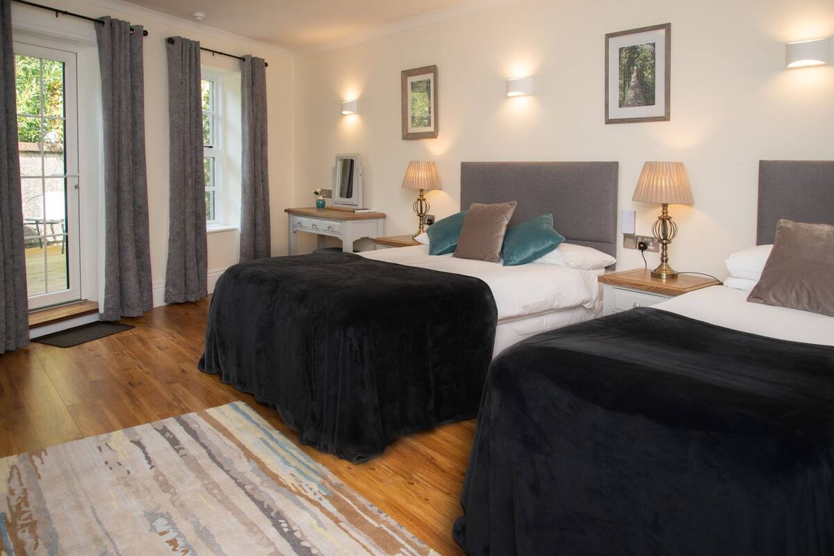Premium bedding, desk, laptop workspace, blackout drapes