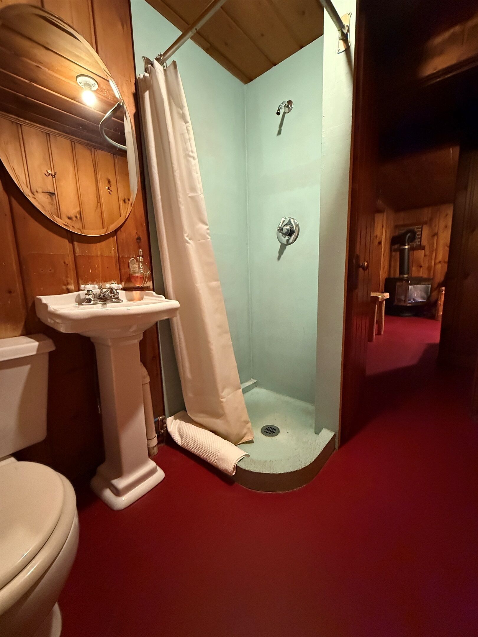Ein Badezimmer mit Dusche, Waschbecken und Toilette.
