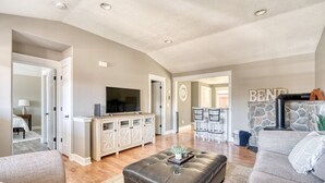 A spacious living room with a large television, a stone fireplace, and a cozy seating area. - Great location in Old Mill District ! ♥ Fenced Backyard,  ♥ Pet Friendly! (Bend)