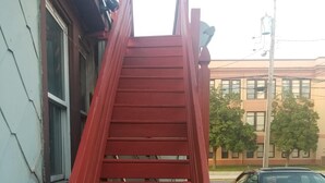 A red staircase leading to a building entrance.