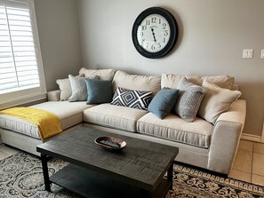 Relax in this inviting living room with a comfortable sofa, coffee table, and patterned rug.