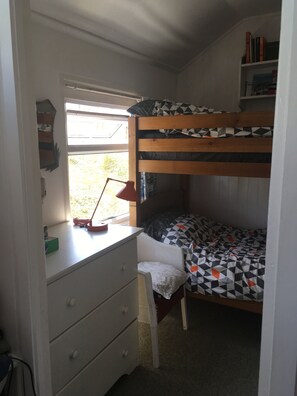 Enjoy a cozy retreat with a bunk bed, desk, and bookshelf.