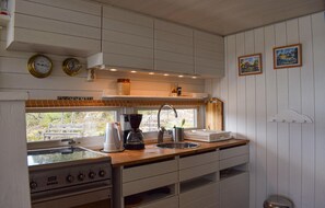 Fridge, stovetop, coffee/tea maker, cookware/dishes/utensils