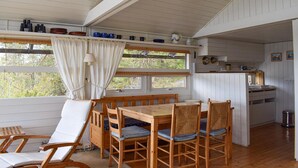 A cozy cabin with a dining area, wooden furniture, and a kitchen. - 4 bedroom beautiful home in Tvedestrand (Tvedestrand)