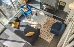 A modern living room with a sofa, armchairs, a coffee table, and a fireplace. - Amazing home in Bruinisse with kitchen (Bruinisse)