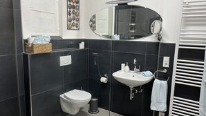 A modern bathroom with a toilet, sink, and mirror. - Dalhaus farm: Our "pantry" (Lüdinghausen)