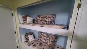 A bunk bed with patterned bedding and a small storage drawer. - Newly renovated with the lowest rates you can find. (Hilton Head Island)