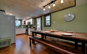 Enjoy meals in this well-equipped kitchen with a dining table, refrigerator, microwave, and oven.