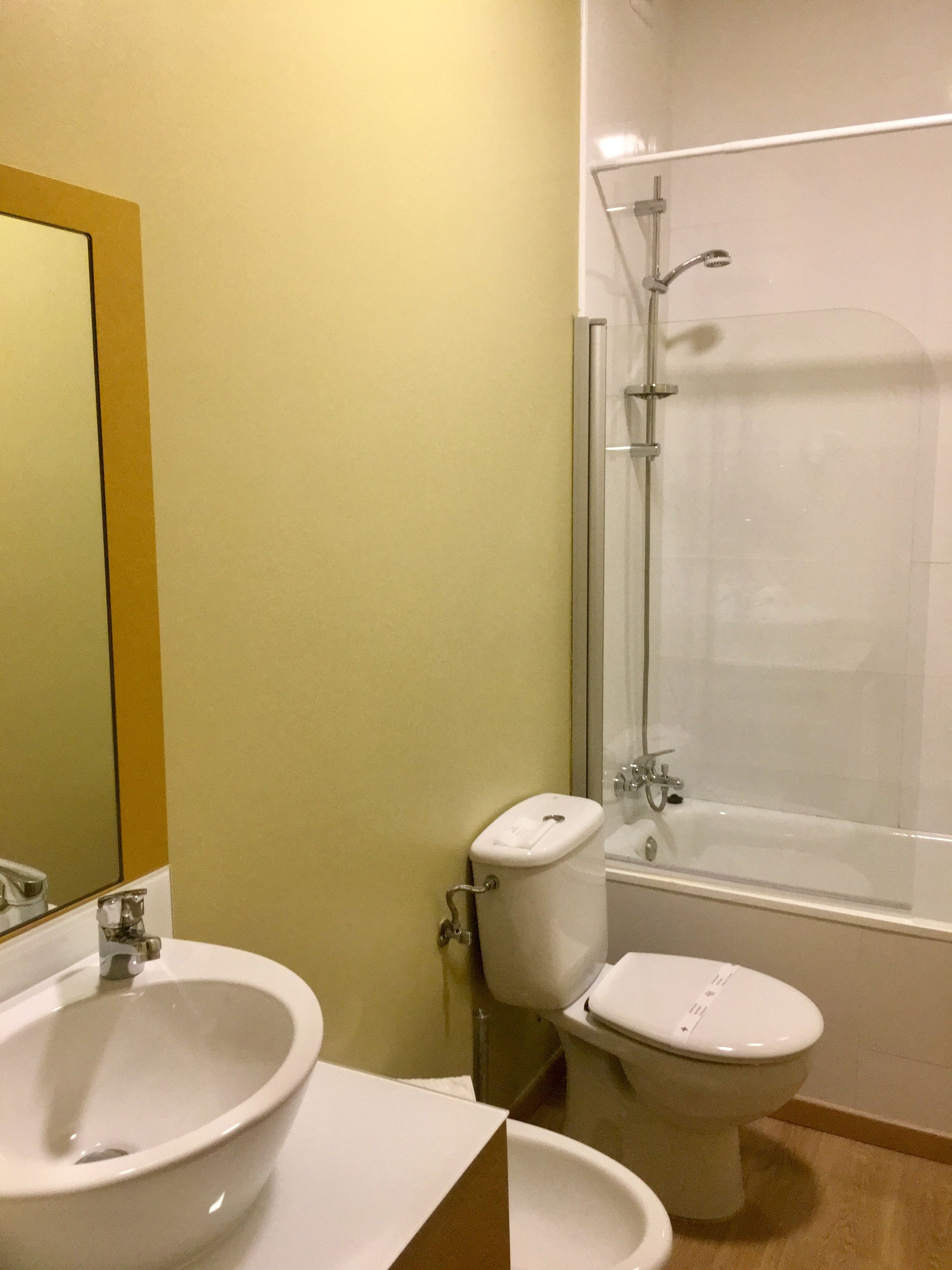 A bathroom with a sink, toilet, and shower.