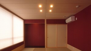 A room with a sliding door, a window with blinds, and a ceiling with recessed lighting. - Kanazawa TAMARUYA (Kanazawa)