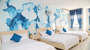 A hotel room with three beds, a large abstract mural on the wall, a ceiling fan, and a window with curtains. - Homestay 78 (Ho Chi Minh City)