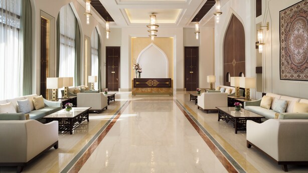 A spacious lobby with a central reception desk, flanked by seating areas and modern chandeliers. - Al Najada Doha Hotel by Tivoli (Doha)