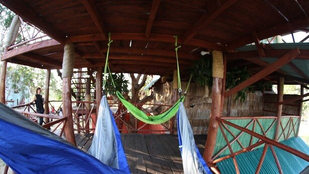 A wooden deck with hammocks and a thatched roof structure. - Eagle Camp Mida Creek (Watamu)