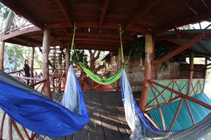 A wooden deck with hammocks and a thatched roof structure. - Eagle Camp Mida Creek (Watamu)