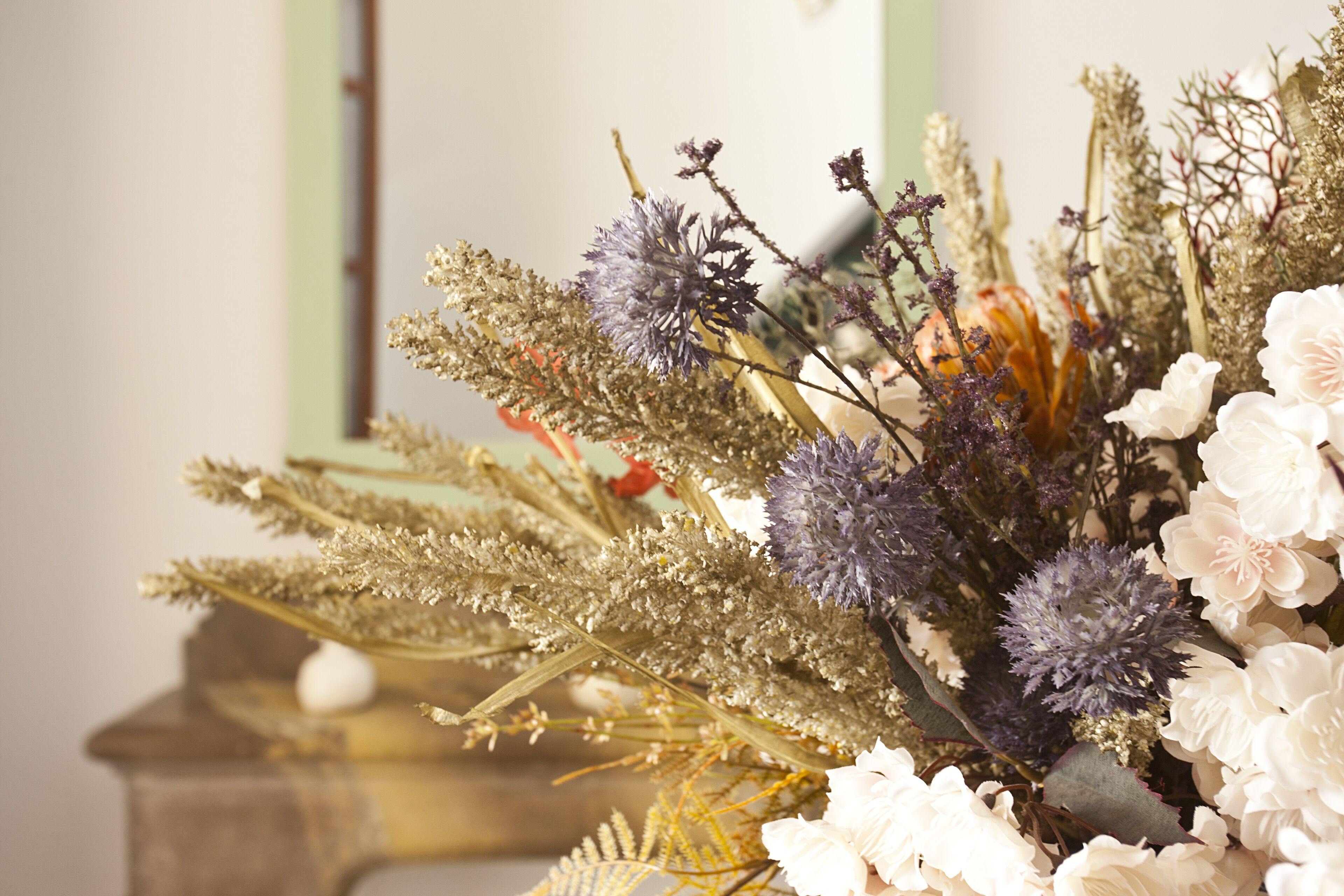 A bouquet of flowers with various types of foliage and blooms.