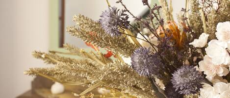 A bouquet of flowers with various types of foliage and blooms.