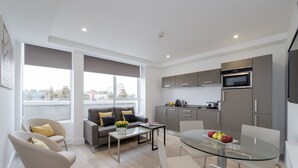 A modern apartment with a living area, dining space, and kitchen.